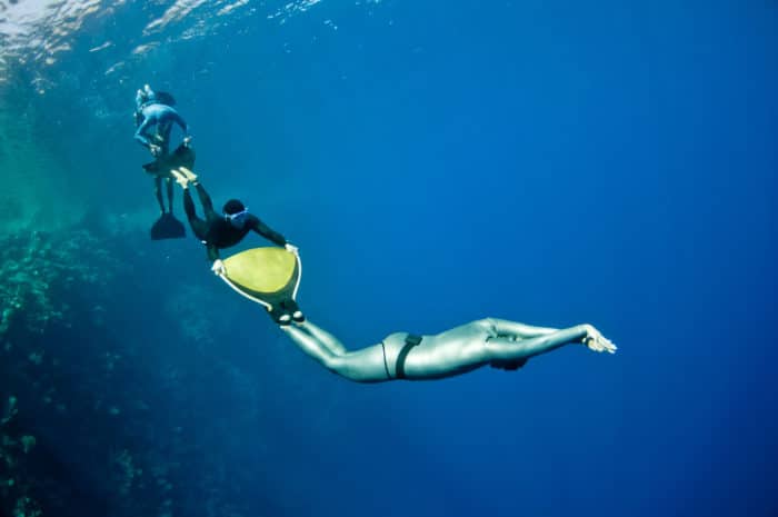 Freedivers having fun together in the sea.
