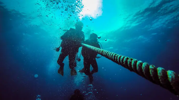 Two scuba divers on an anchor rope