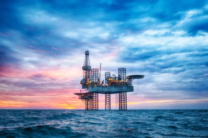 Offshore Jack Up Rig in The Middle of The Sea at Sunset