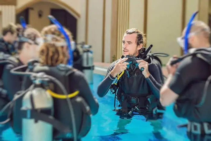 Scuba Diving Gear - Students Practicing in the Pool with their Scuba Diving Equipment