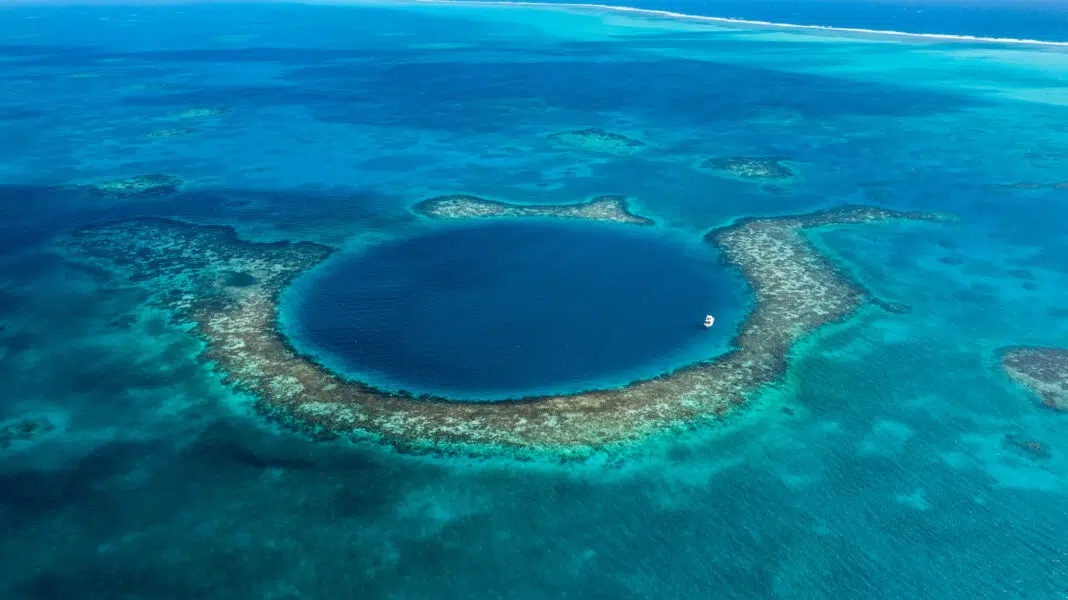 Aerial view of the Belize Blue Hole, UNESCO Heritage site to experience while Belize Scuba Diving