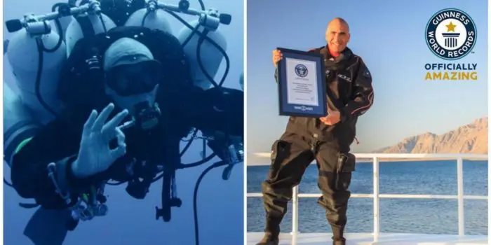 Ahmed Gabr holding the Guinness World Record certificate for his dive